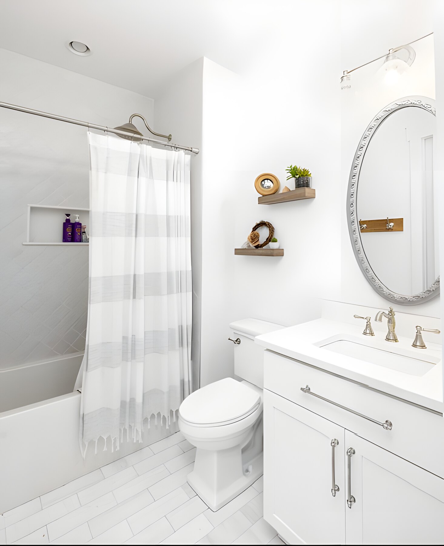 Guest bath with tiled tub-shower and oval mirror