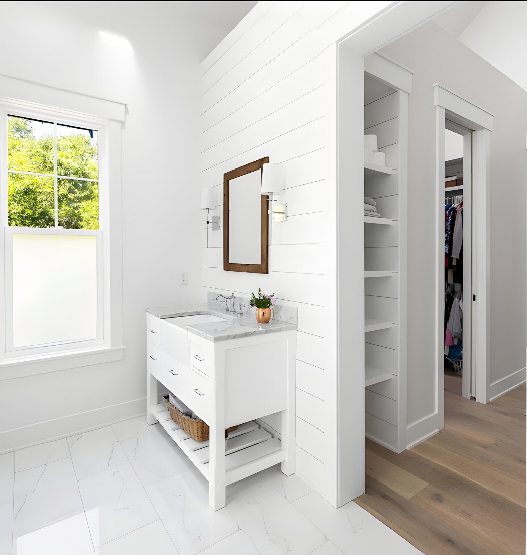 Shiplap vanity with marble top open to a walk-in closet